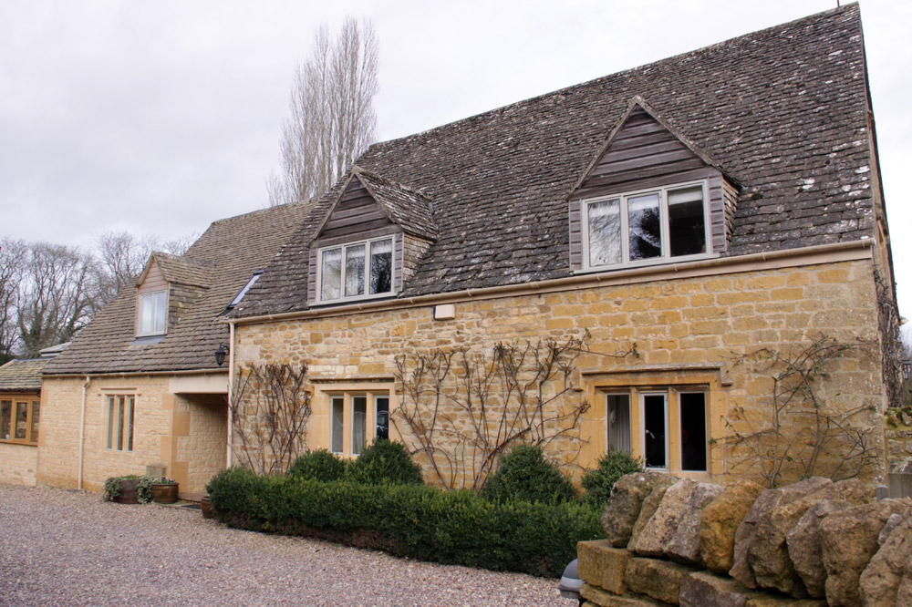 Detached house and outbuildings with stone walls and stone slated roof